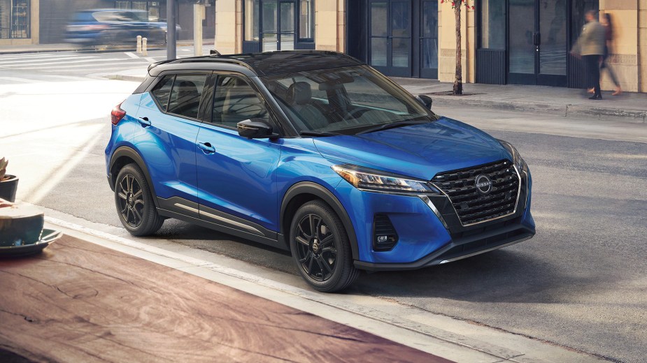 A blue 2023 Nissan Kicks SUV sits on the side of the road.