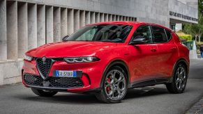 A red 2023 Alfa Romeo Tonale Veloce plug-in hybrid electric vehicle (PHEV) compact SUV model