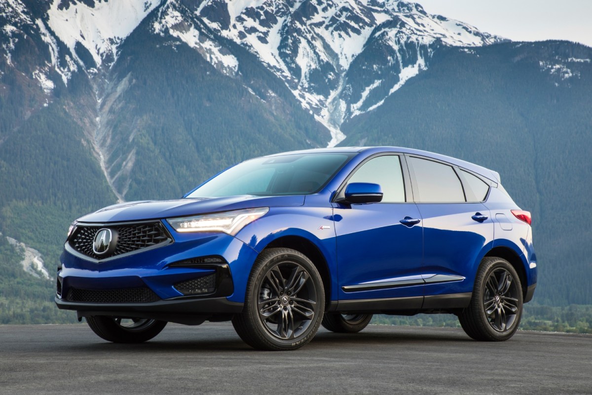 A blue Acura RDX parked in front of a snowy mountain. The RDX is one of the best small luxury SUVs.