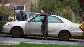 A father and son searching for auto insurance for an old Toyota car in Toronto, Ontario, Canada