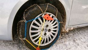 A Fiat car with a tire chain attached for winter and snowy weather driving conditions