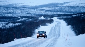 A car towing during winter on a snow covered road.