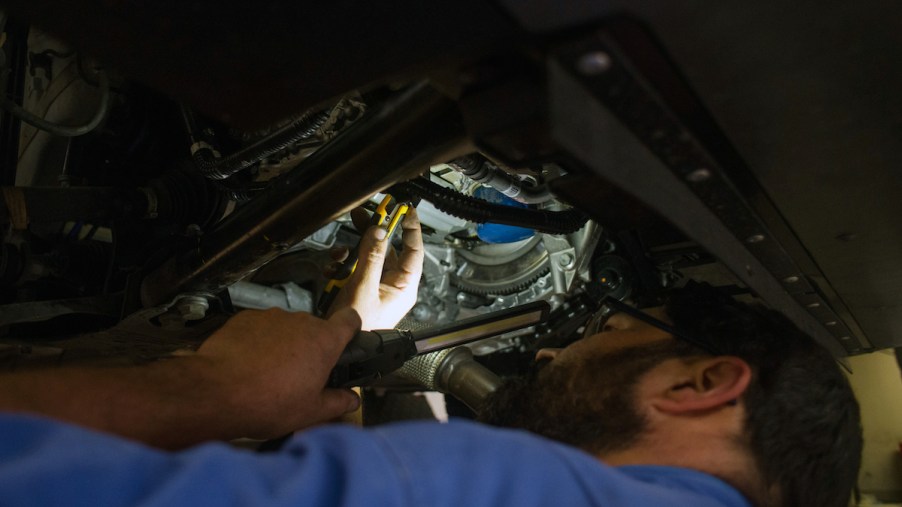 A mechanic working on a car potentially luxury brands with the most expensive 10-year maintenance