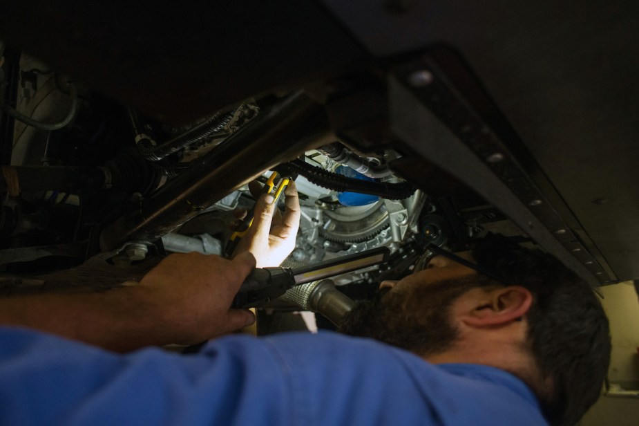 A mechanic working on a car potentially luxury brands with the most expensive 10-year maintenance