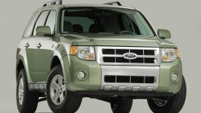 A promo photo of a light green 2008 Ford Escape SUV.