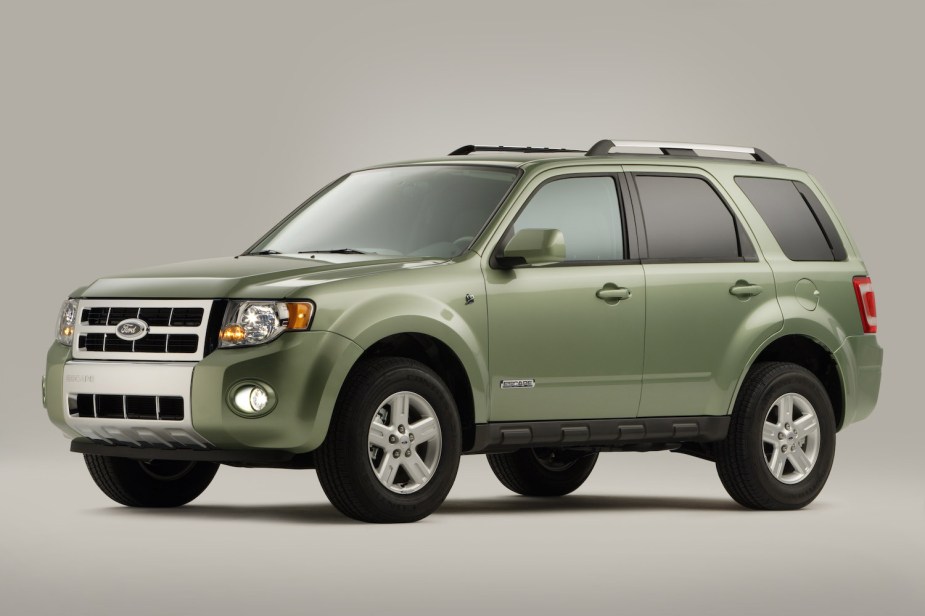 The side of a green 2008 Ford Escape hybrid SUV.