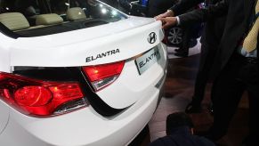 A white 2012 Hyundai Elantra on display at an auto show.
