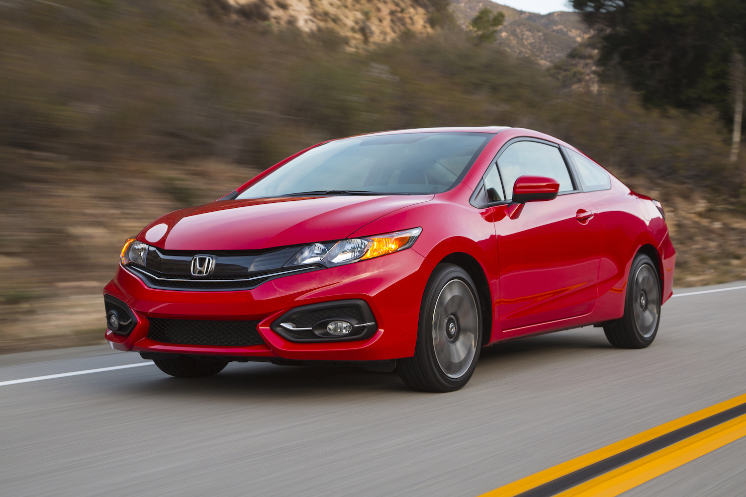 A red 2014 Honda Civic Coupe driving
