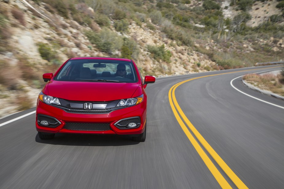 A red 2014 Honda Civic Coupe driving