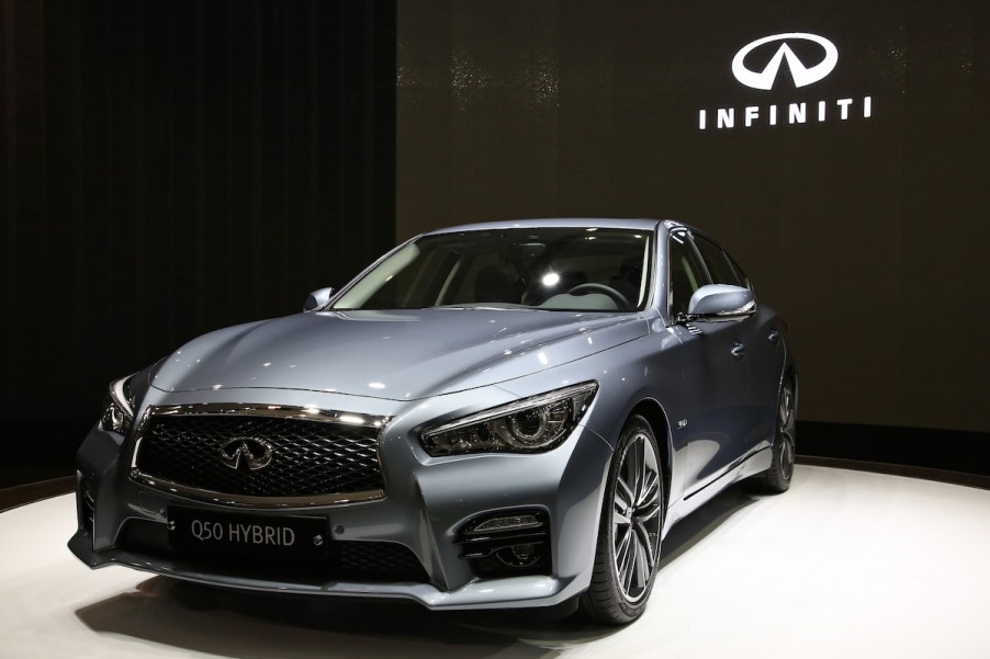 The 2014 Infiniti Q50 in front of black background.