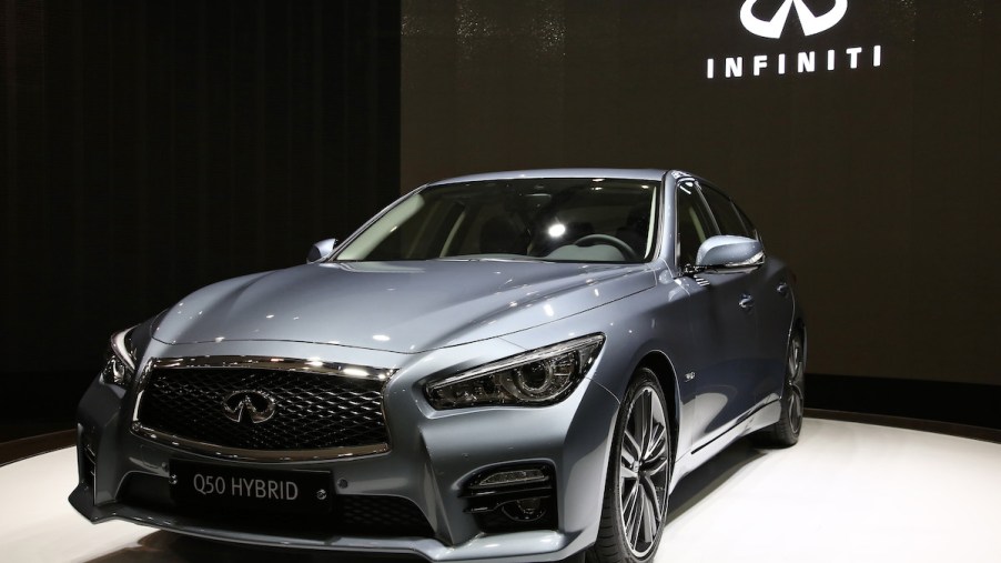 The 2014 Infiniti Q50 in front of black background.