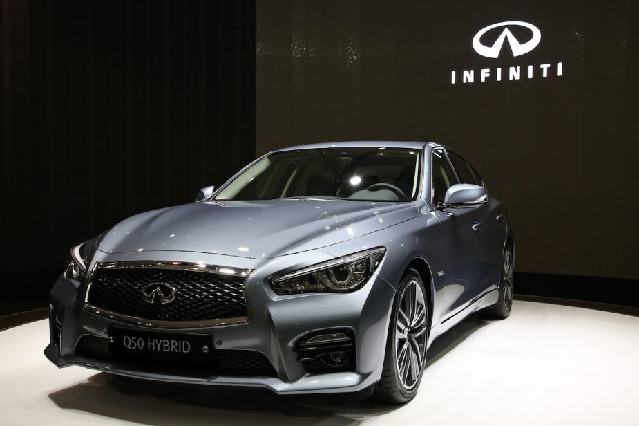 The 2014 Nissan Infiniti Q50 in front of black background. 