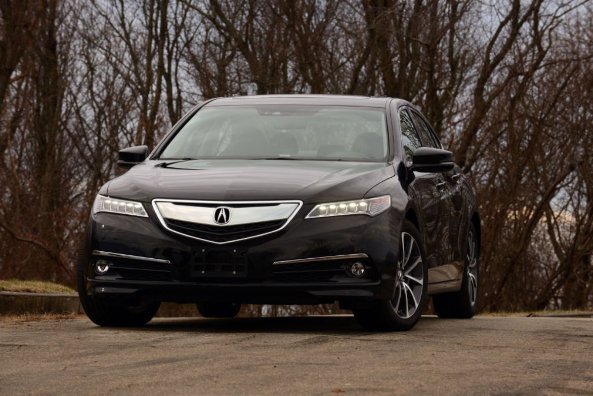 A black 2015 Acura TLX driving down the road