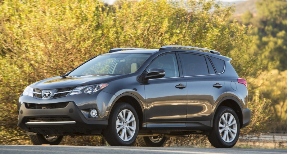 A gray 2015 Toyota RAV4 small SUV is parked. 