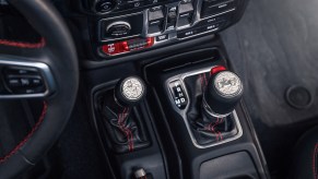 Detail photo of a Jeep Wrangler's automatic transmission and manual transfer case shift levers.