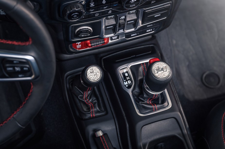 Detail photo of a Jeep Wrangler's automatic transmission and manual transfer case shift levers.