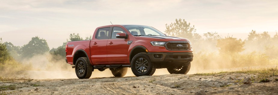 The Ford Ranger Lariat tremor midsize pickup truck parked for a promo photo in the middle of an off-road trail.