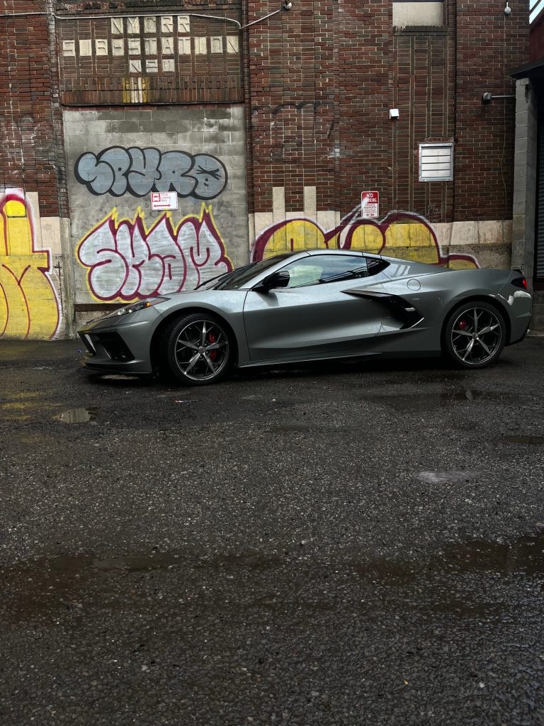 MotorBiscuit Car of the year:2022 Chevrolet C8 Corvette in front of graffiti