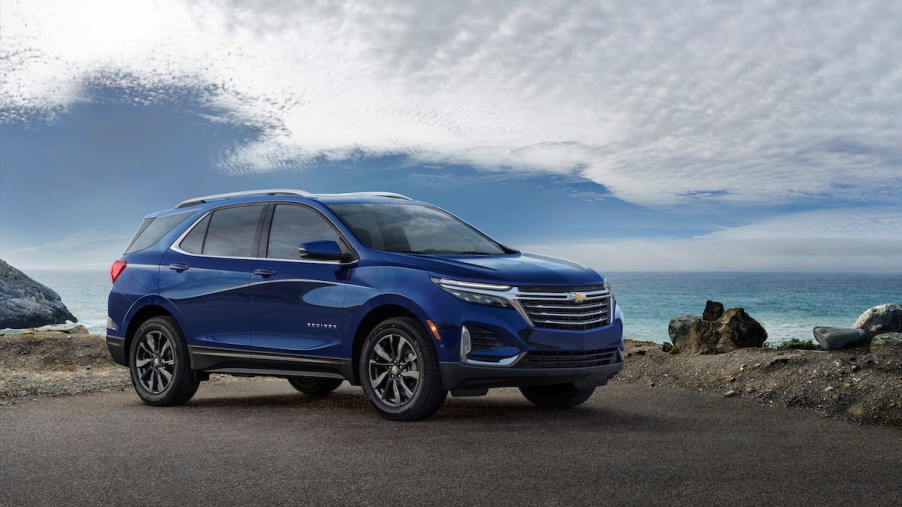A blue 2023 Chevrolet Equinox parked in a driveway.