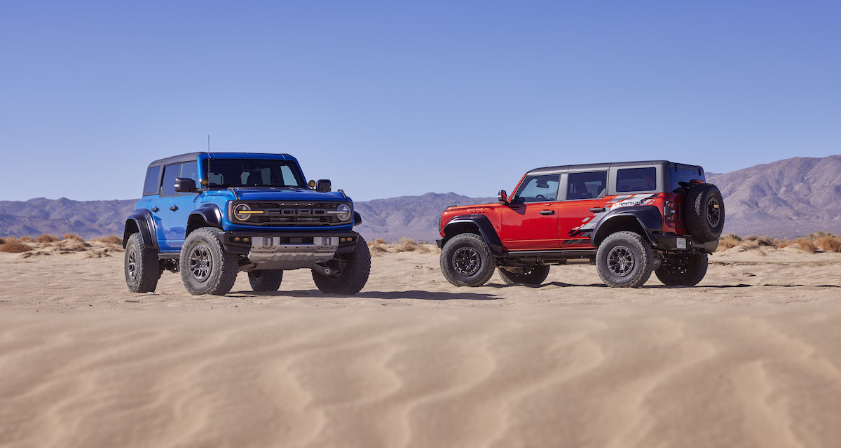 A red and blue Ford Bronco in the desert.