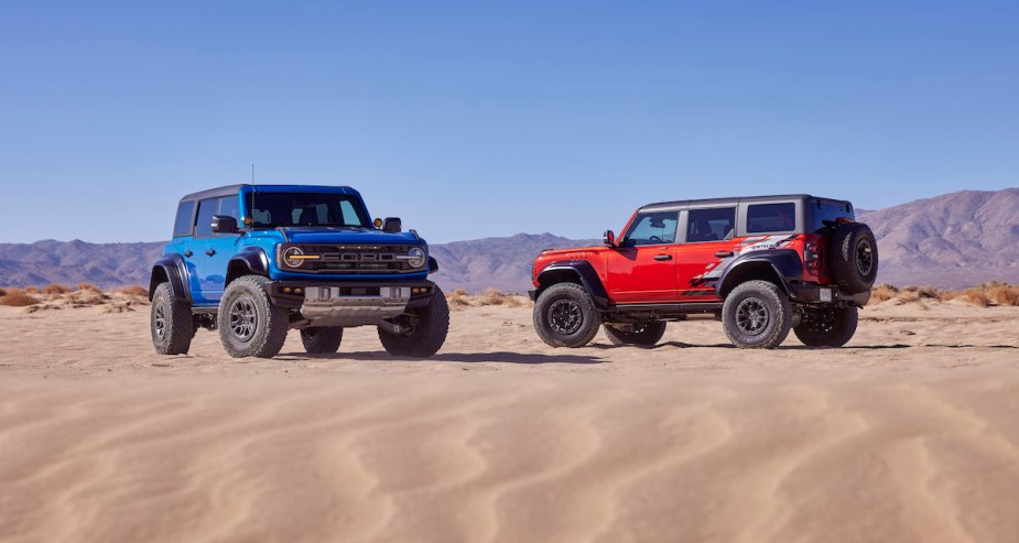 A red and blue Ford Bronco in the desert.