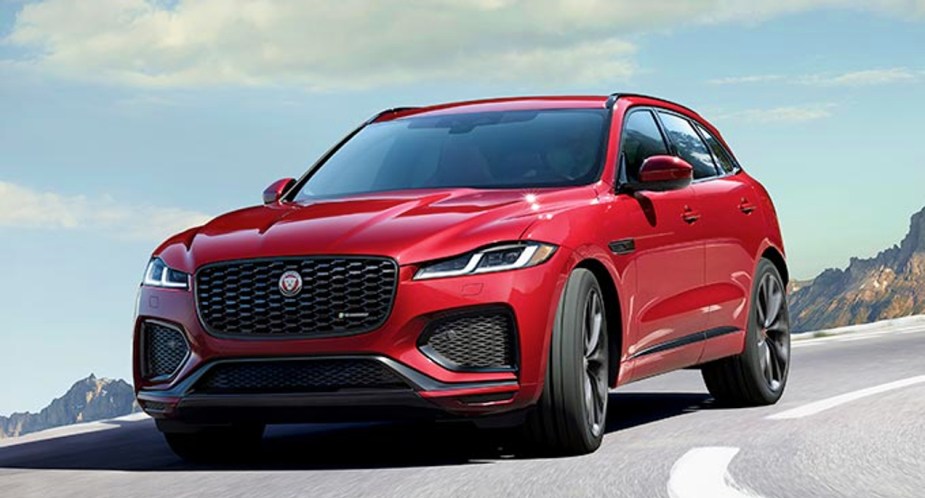 A red 2022 Jaguar F-PACE is driving on the road. 