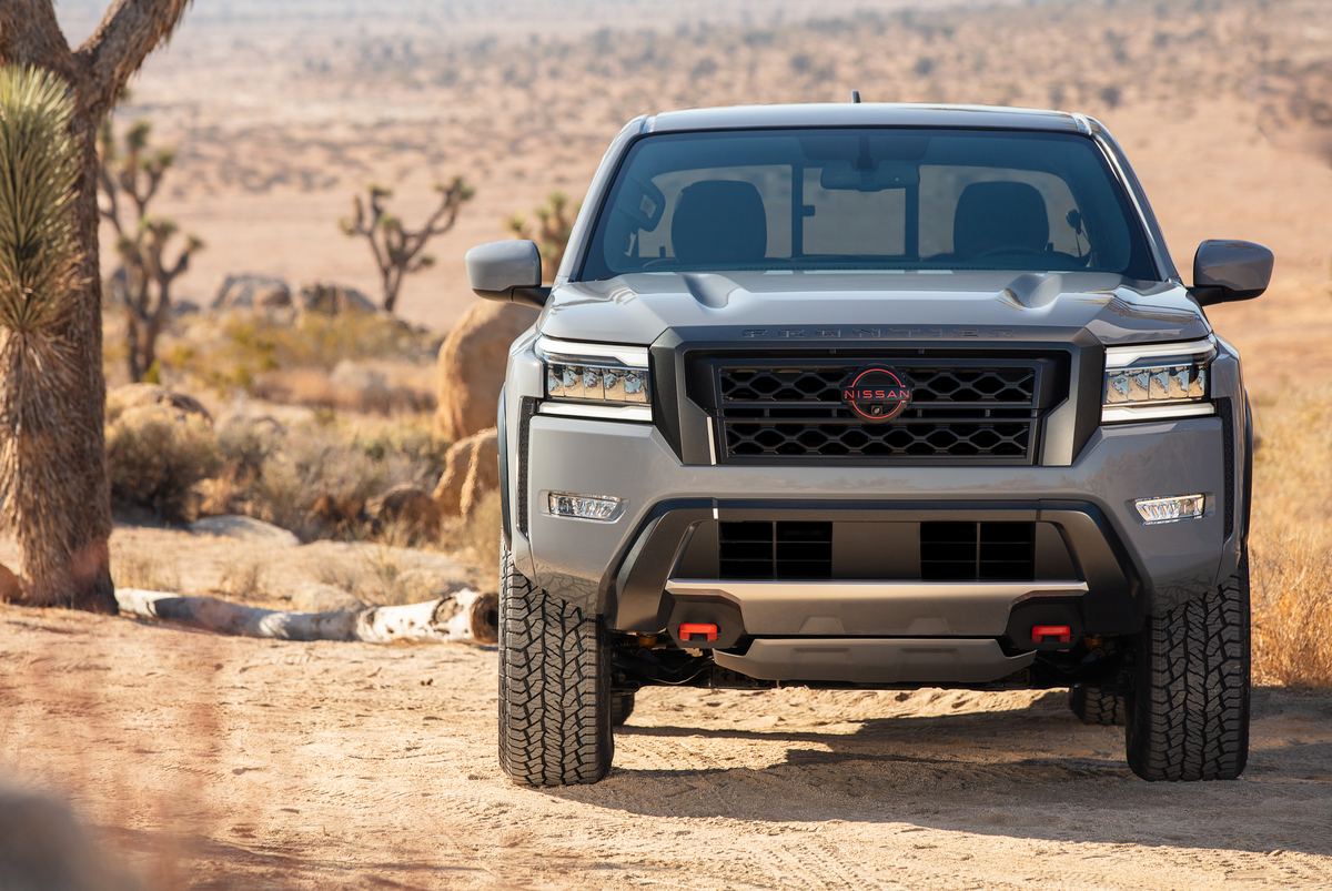 A 2022 Nissan Frontier on display in a desert.