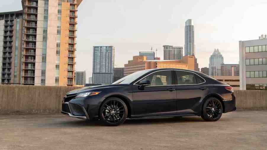 A Black 2022 Toyota Camry midsize sedan parked in a parking garage