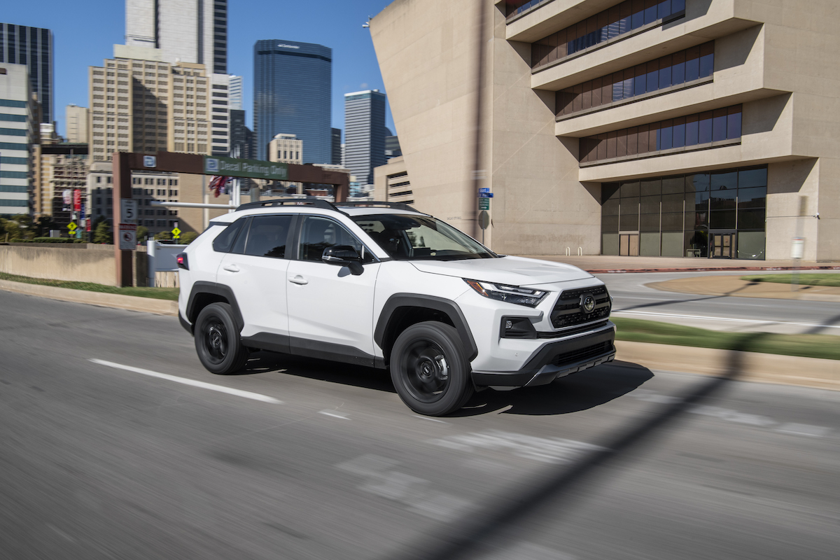 A white 2022 Toyota RAV4 which shows the advantages the 2022 Toyota RAV4 as it drives down the road.