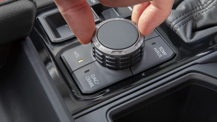 Closeup of a driver's hand spinning the MTS knob on a Toyota pickup truck.