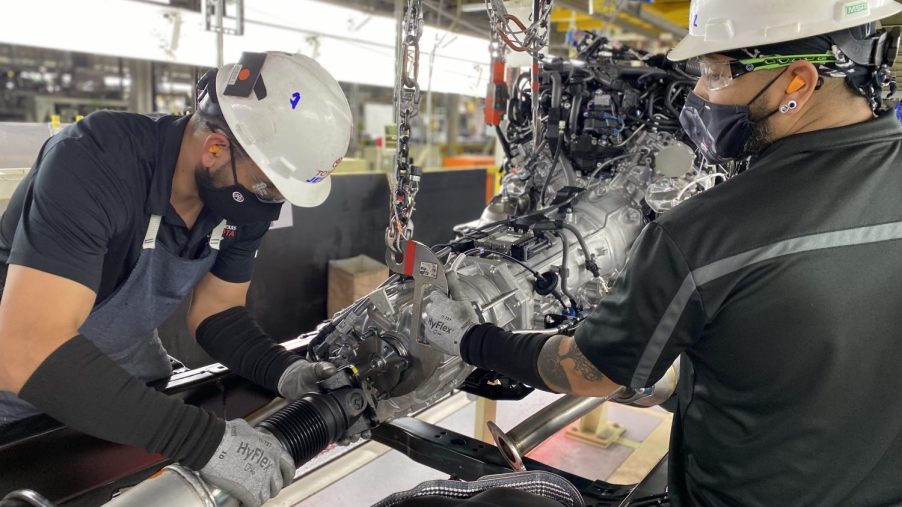 Two San Antonio factory workers assemble the hybrid Toyota Tundra pickup truck's 10-speed automatic transmission.