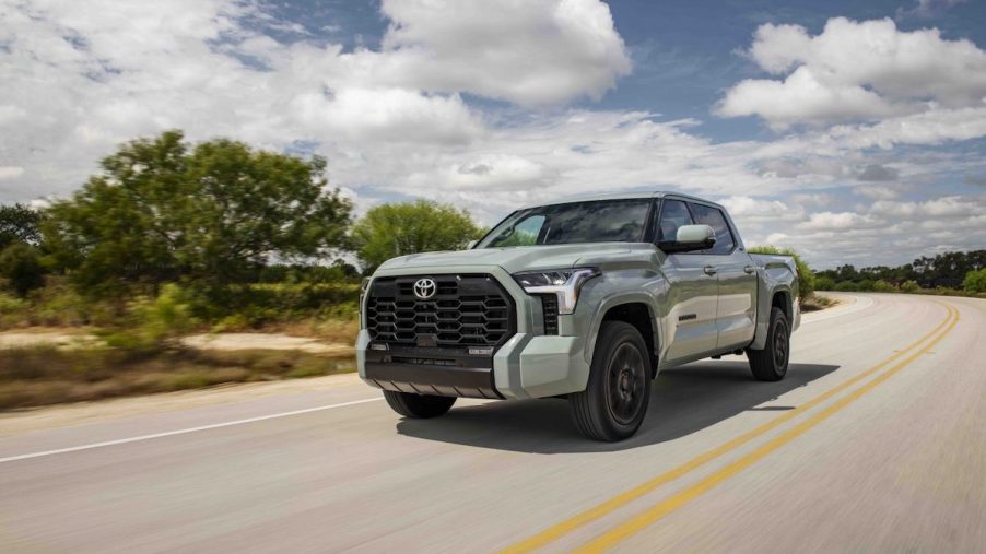 A silver 2022 Toyota Tundra driving down the road.