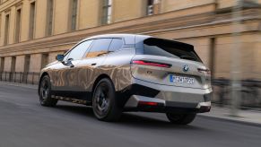 A 2023 BMW iX driving down a city street