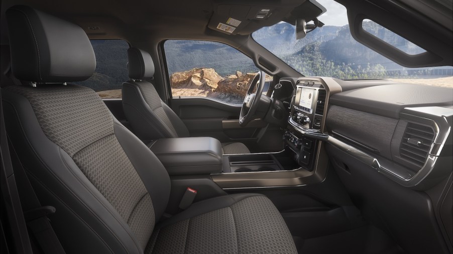 The interior of Ford's entry-level F-150 XL trim outfitted with cloth seats, a mountain range visible outside the window.