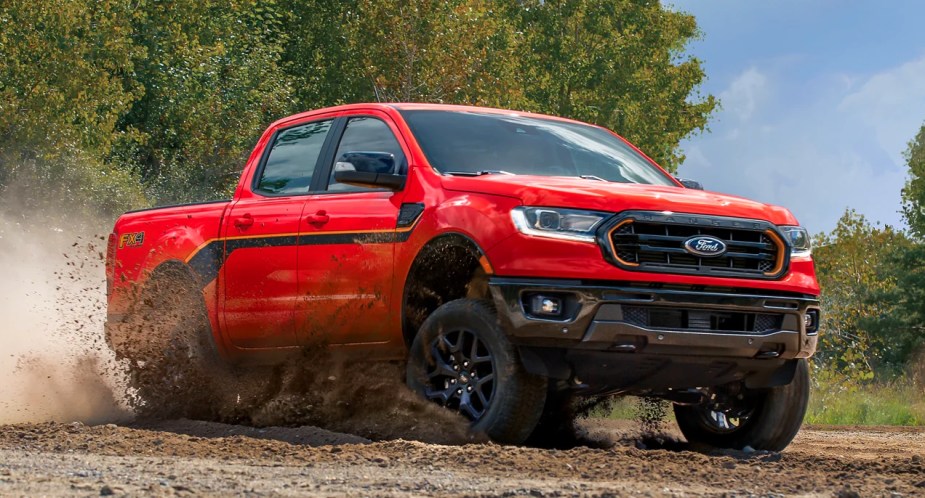 A red 2023 Ford Ranger is driving off-road. 