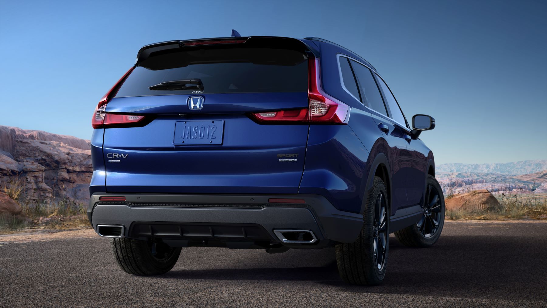A blue 2023 Honda CR-V Sport Touring compact SUV model with a hybrid powertrain and a spare tire in its trunk