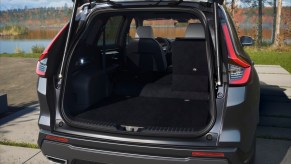 A dark color 2023 Honda CR-V as a one of the small SUVs with the most cargo space with its trunk open.