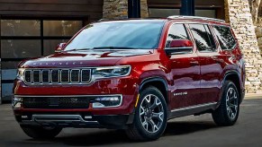A red 2023 Jeep Grand Wagoneer large luxury SUV is parked.