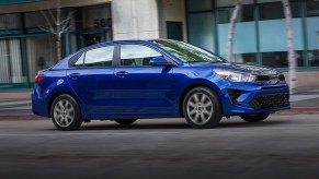 A blue 2023 Kia Rio with the cheapest 5-year ownership costs.