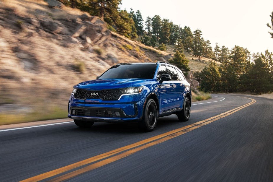 2023 Sorento SX in blue driving down the highway
