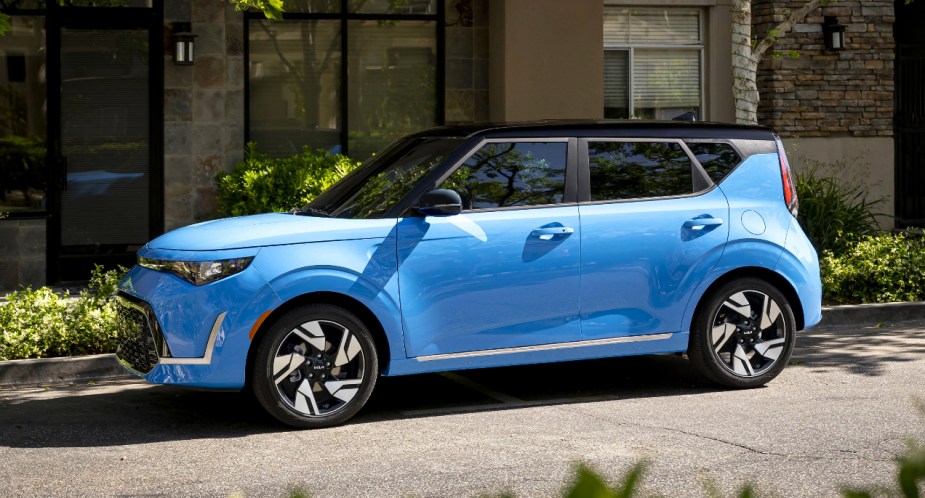 A blue 2023 Kia Soul subcompact SUV is parked on the road. 