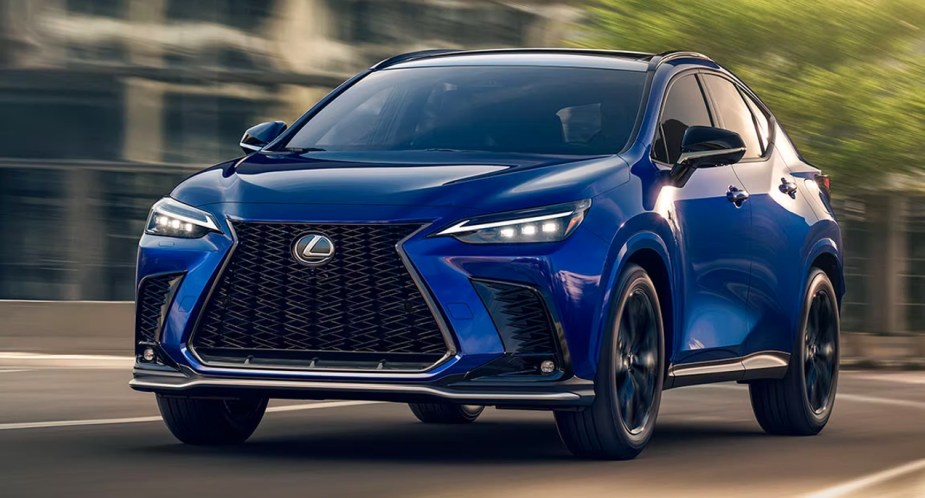 A blue Lexus NX 350h small luxury hybrid SUV is driving on the road.