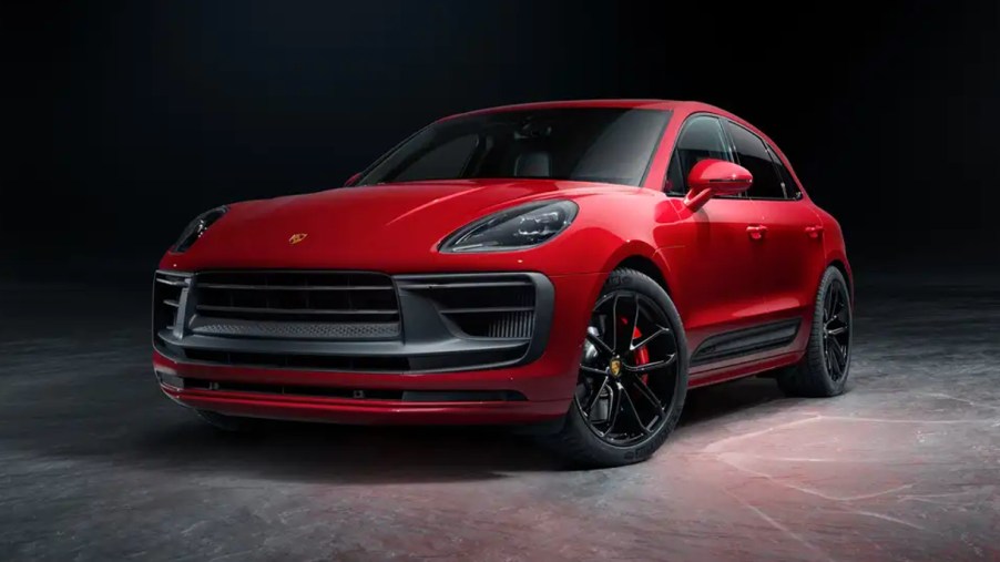 A red 2023 Porsche Macan small luxury SUV is parked.