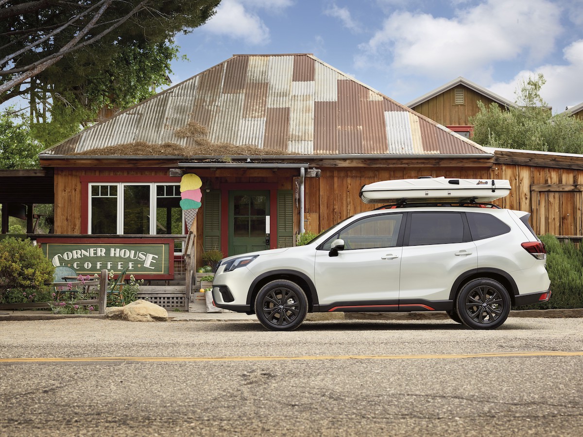 A white 2023 Subaru Forester parked outside a home, which is one of the best new small SUV under $30,000