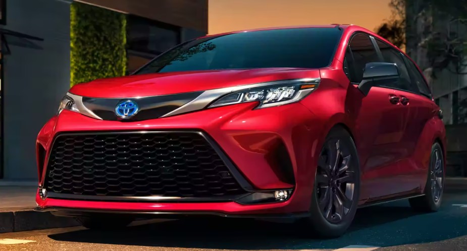 A red 2023 Toyota Sienna is parked.