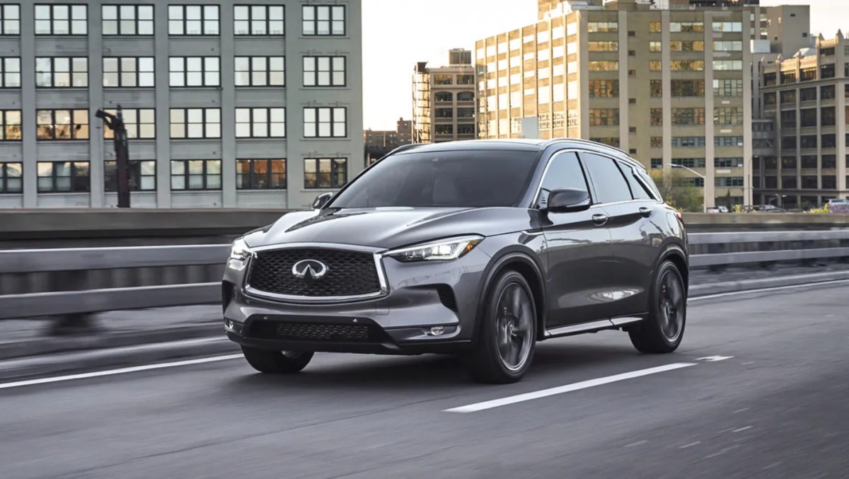 a gray 2023 Infiniti QX50 luxury compact SUV driving on a road, experts agree on the best trim.