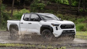 The 2024 Toyota Tacoma Hybrid splashing through mud