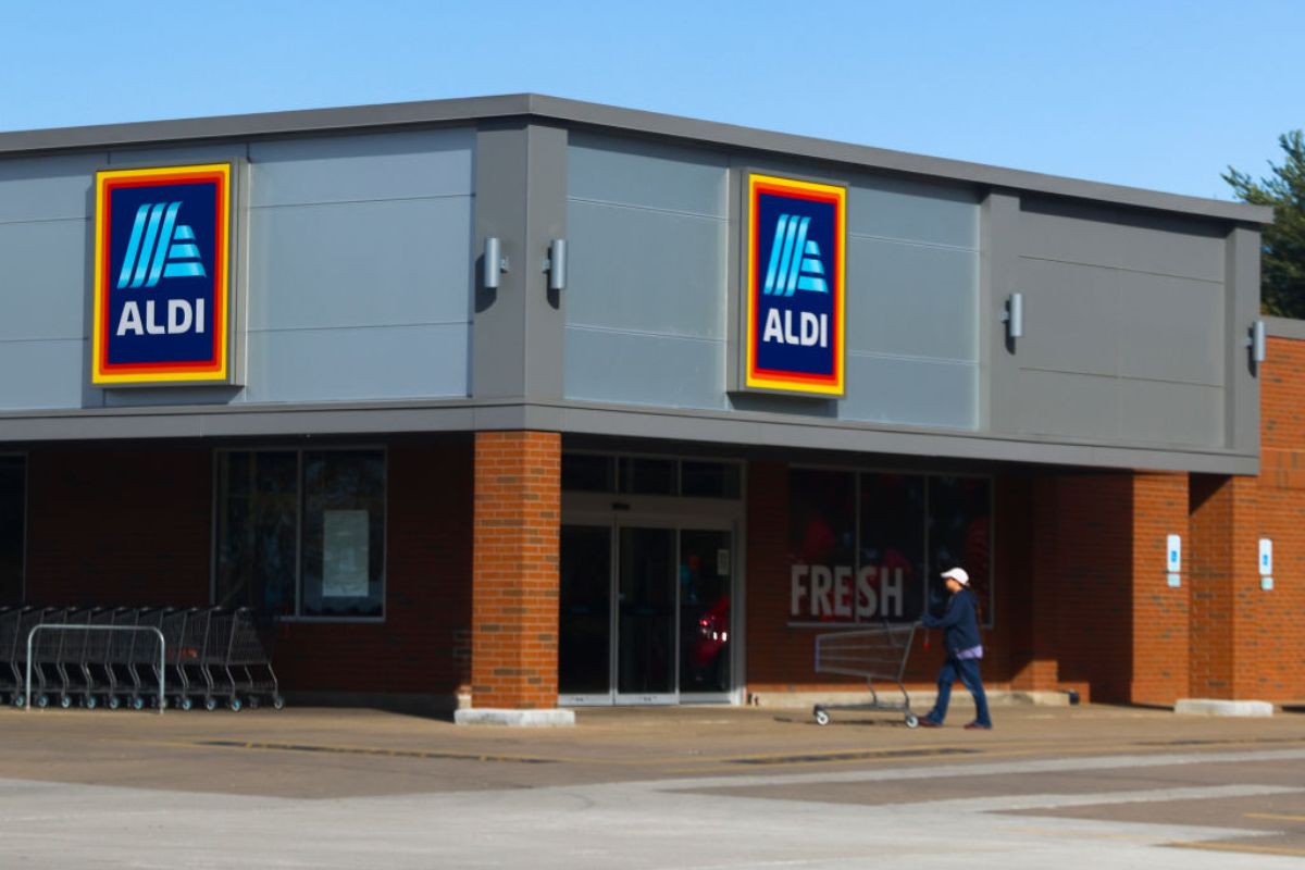 A person walking into an Aldi grocery store