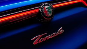 The logo and badging of an Alfa Romeo Tonale luxury plug-in hybrid electric vehicle (PHEV) model