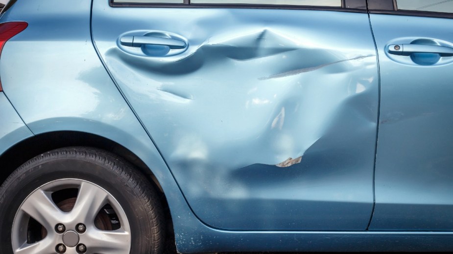 Blue Car With Dents, these dents can lower the trade-in value of a car